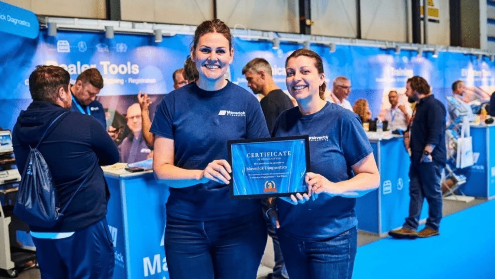 Laura and Beth at Automechanika holding the customer engagement award